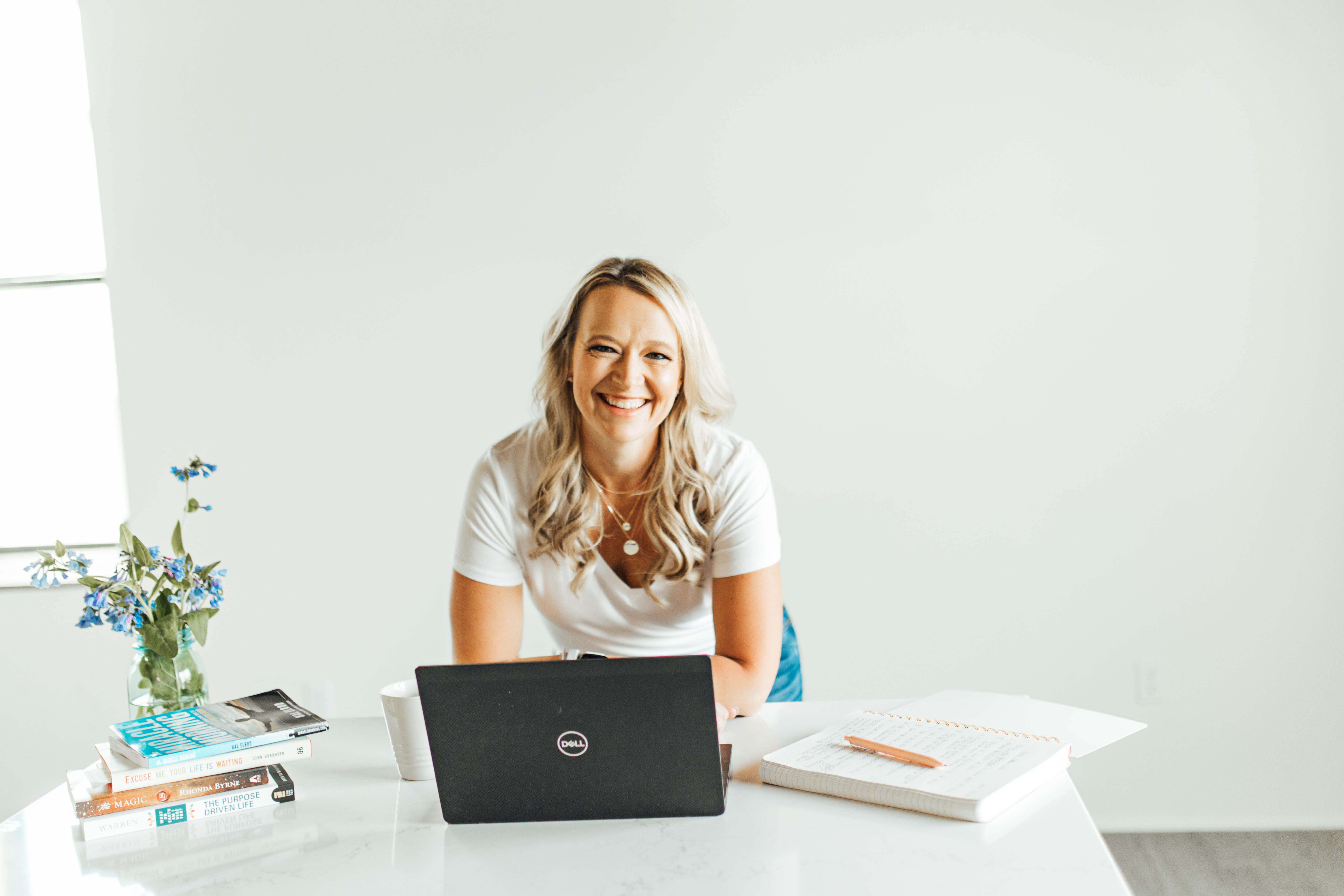 Mandi Rodgers leaning over a table behind a computer